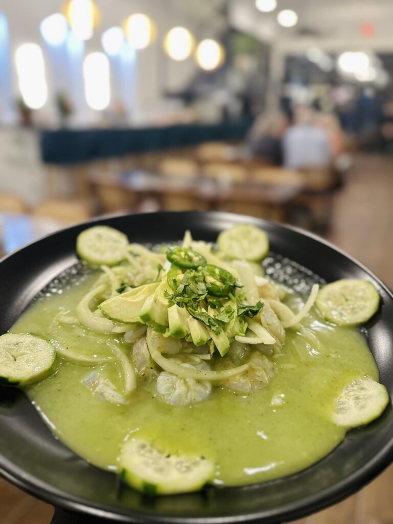 Aguachile- Sliced shrimp Marinated/cooked in lime accompanied with Avocado,onion,cucumber cilantro and a side of Homemade Tostadas