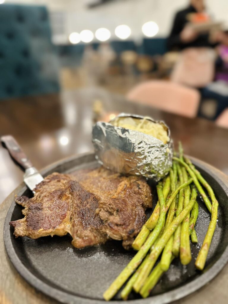 Ribeye Steak- accompanied with a baked potato, asparagus and a tossed Salad