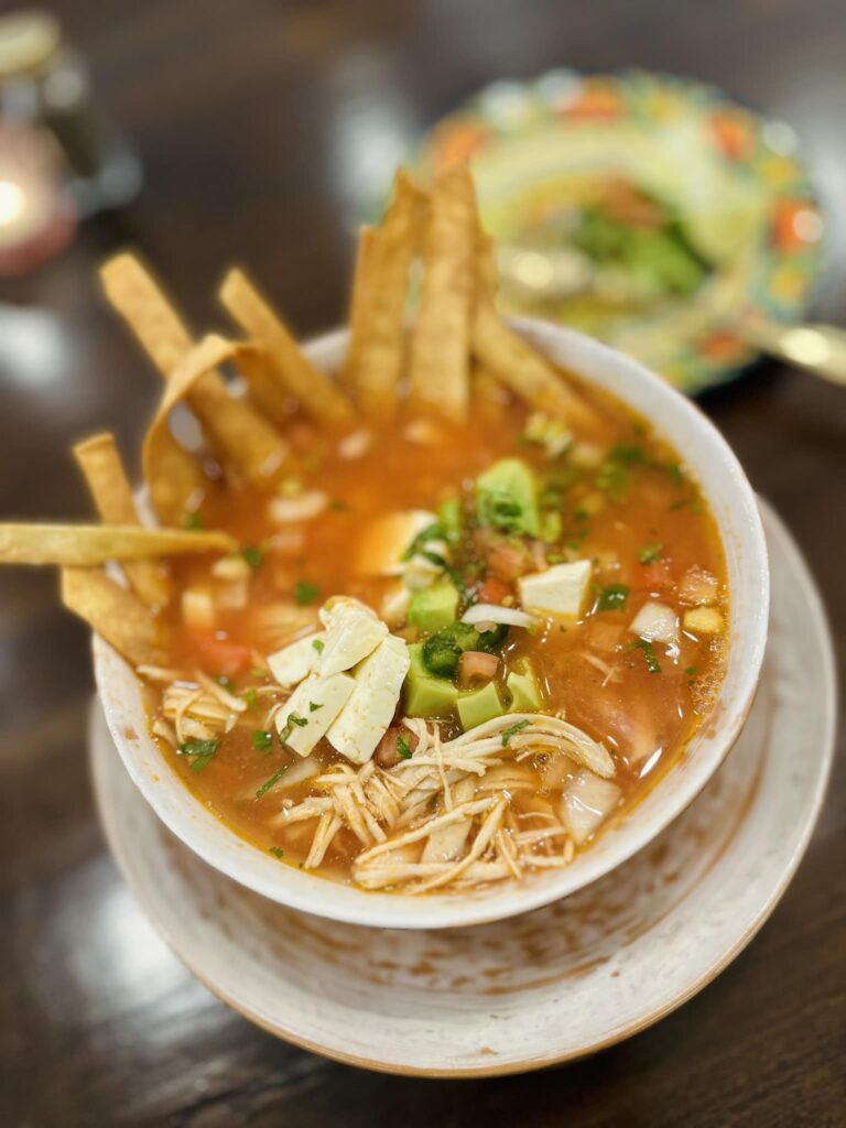 Sopa Azteca- Chicken, Panela Cheese, rice, pico de gallo, avocado, lime accompanied with home made tortilla Strips